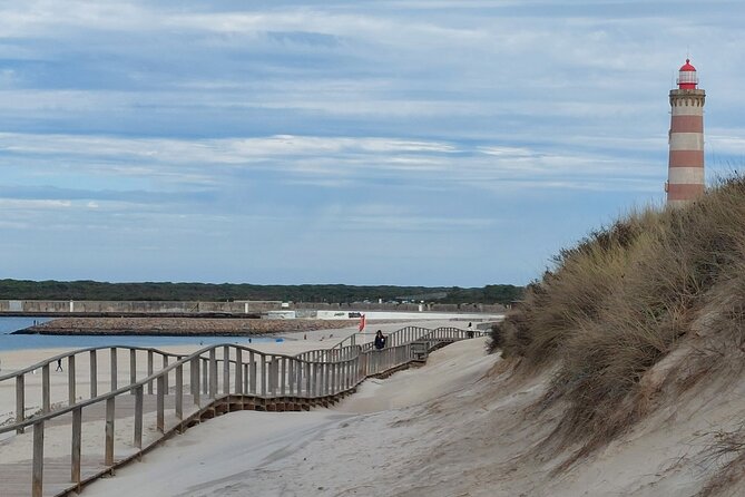 From Aveiro: Costa Nova, Barra, Vista Alegre - Half-Day Trip - Praia da Barra: the sea opening, old wall stone, and lighthouse views
